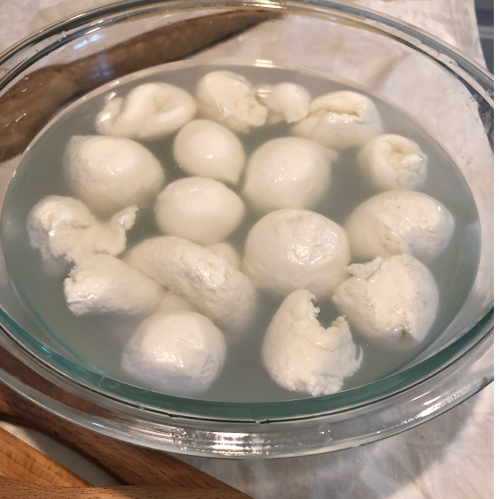 mozzarella cheese balls soaking in cold salt water