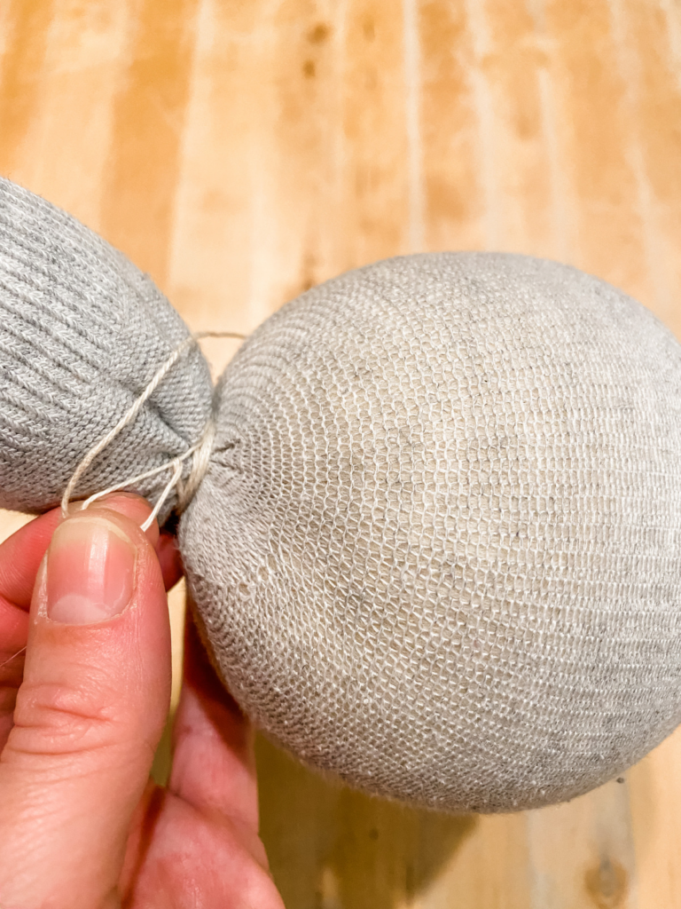 cotton thread around a stocking over a wool ball