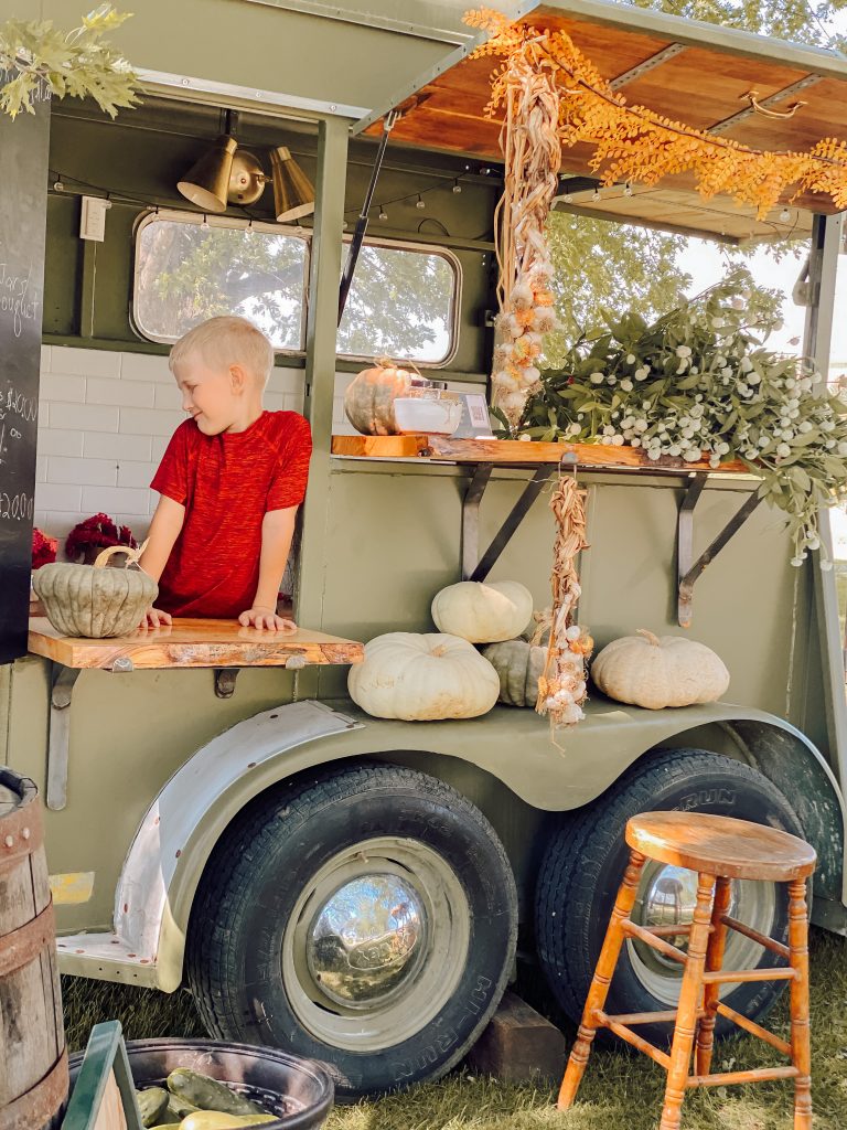 little boy standing in the hearty hopper trailer window