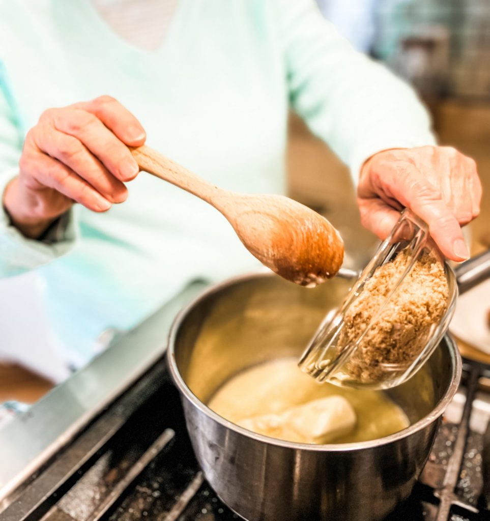 pouring brown sugar into the pan