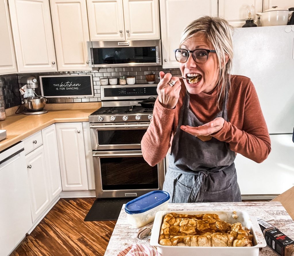 eating a cinnamon roll in the kitchen