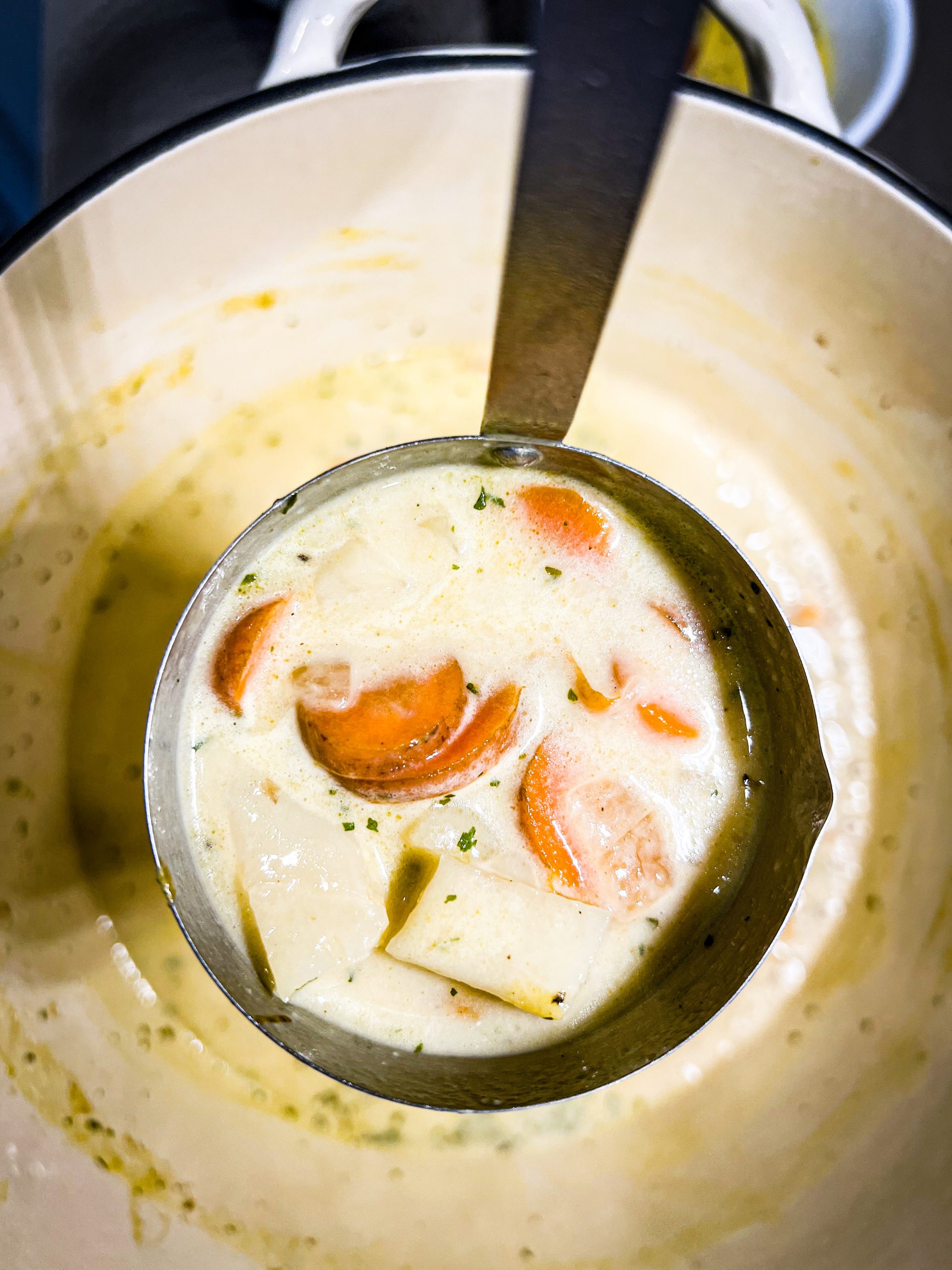creamy potato soup in a ladle