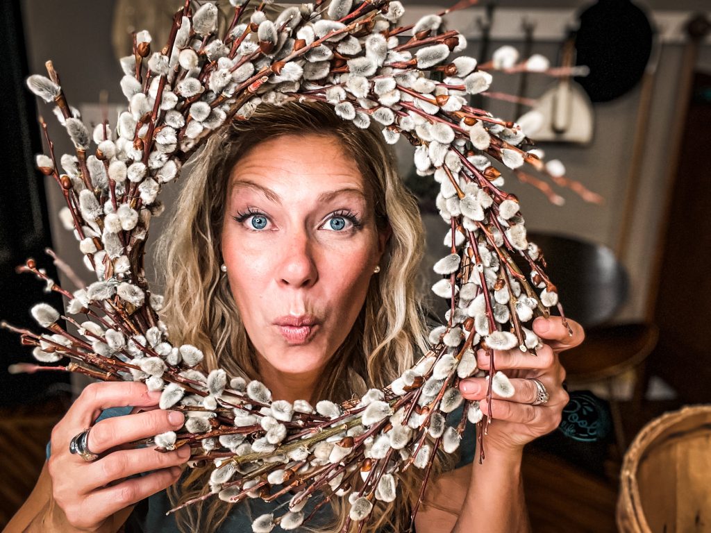 holding a pussy willow wreath