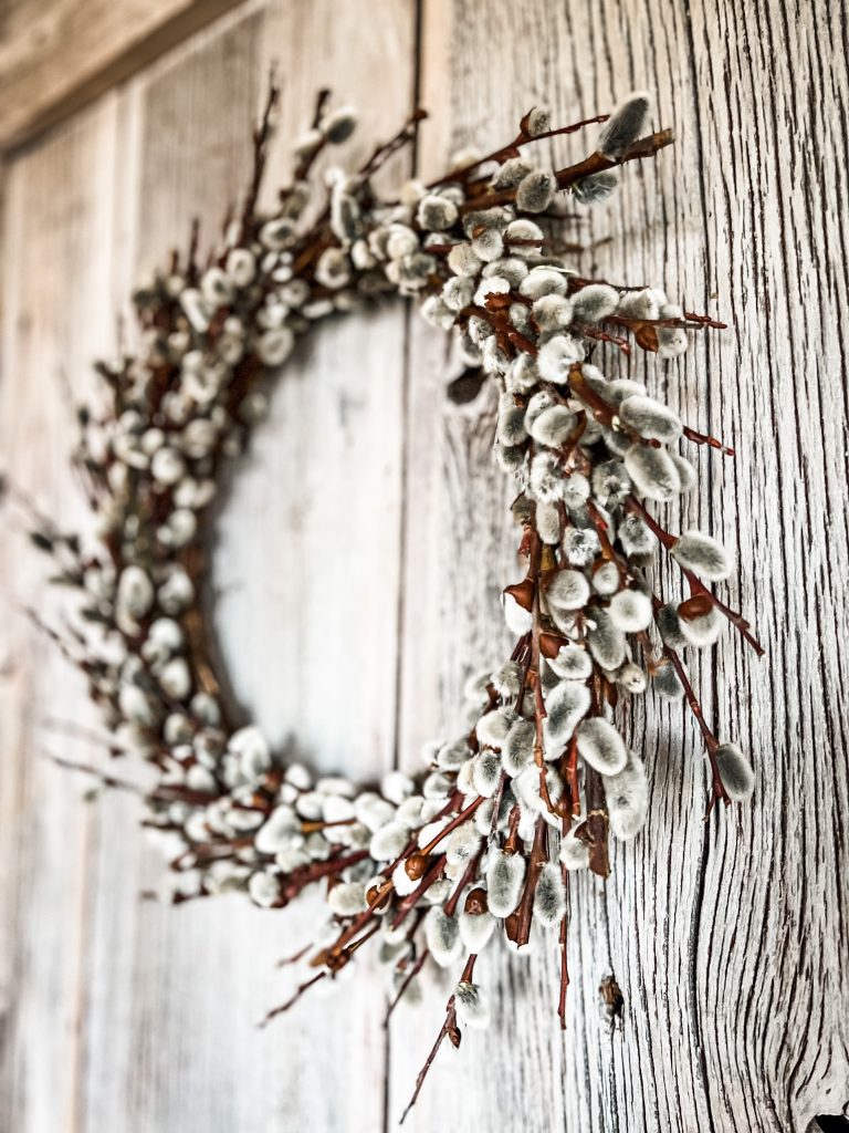 pussy willow wreath hanging on a door