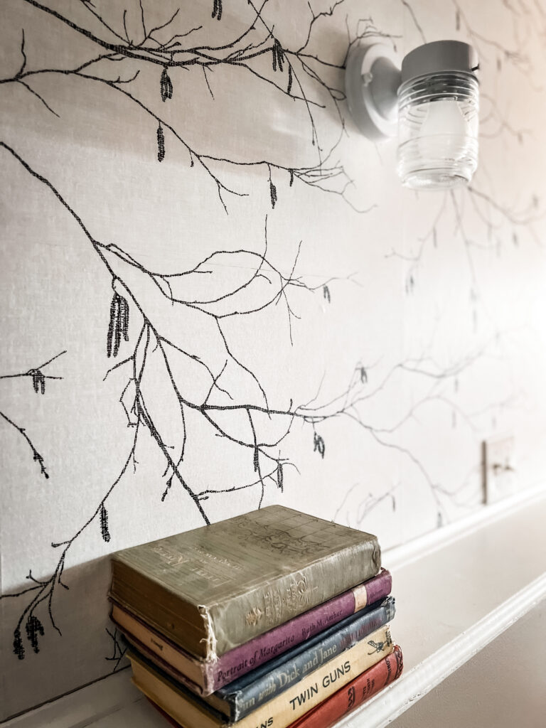 wallpaper, a light fixture and books