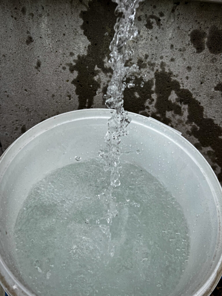 pouring water into a bucket
