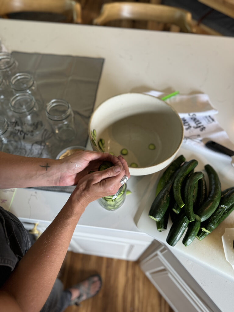 packing jars with sliced cucumbers