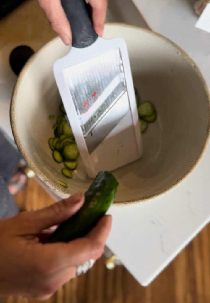 using a mandoline to slice cucumbers