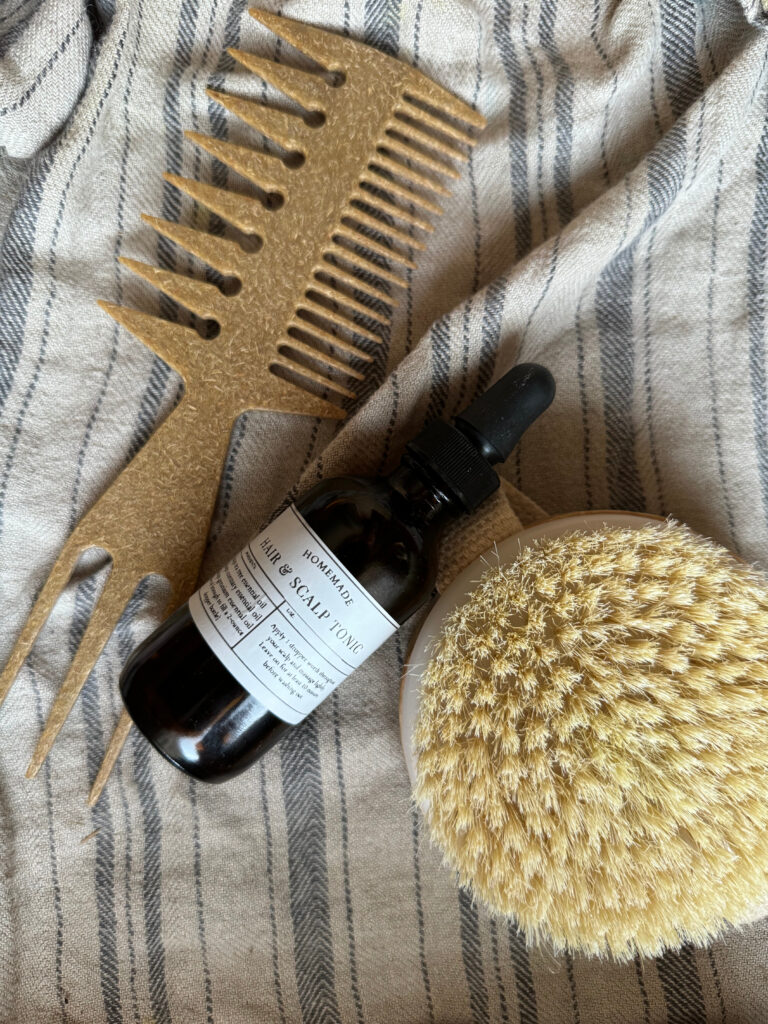 hair tonic with bamboo comb and dry brush