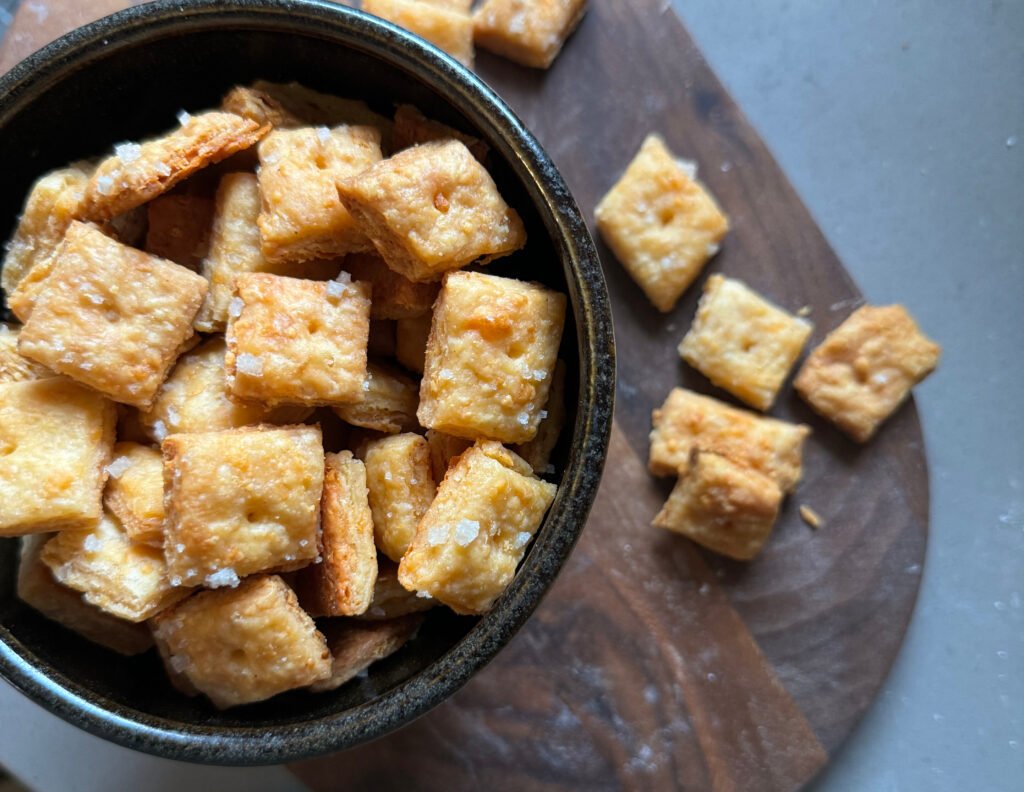 homemade cheez-its in a black bowl