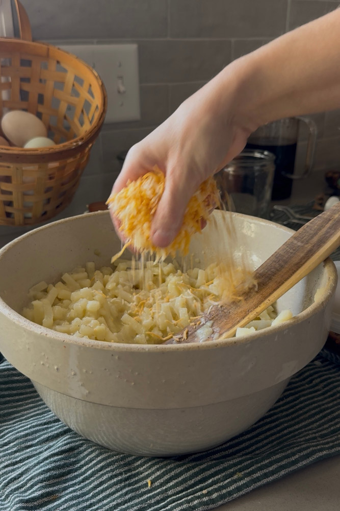 Mixing julienne potatoes and cheese