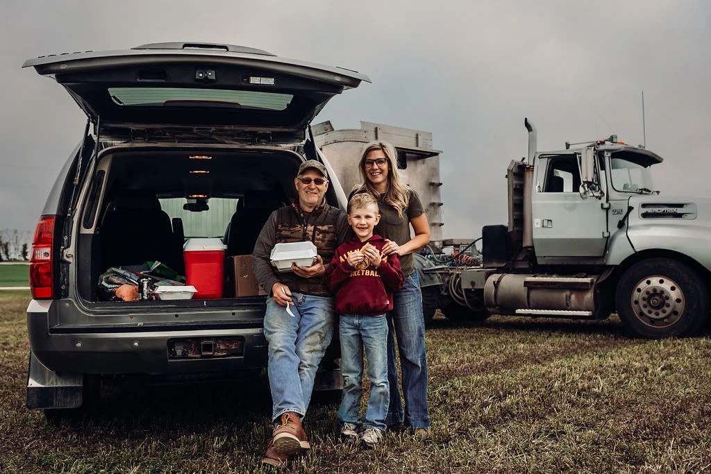 Family on their farm with a field meal